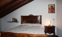 Queen's bed on attic above the double bedroom